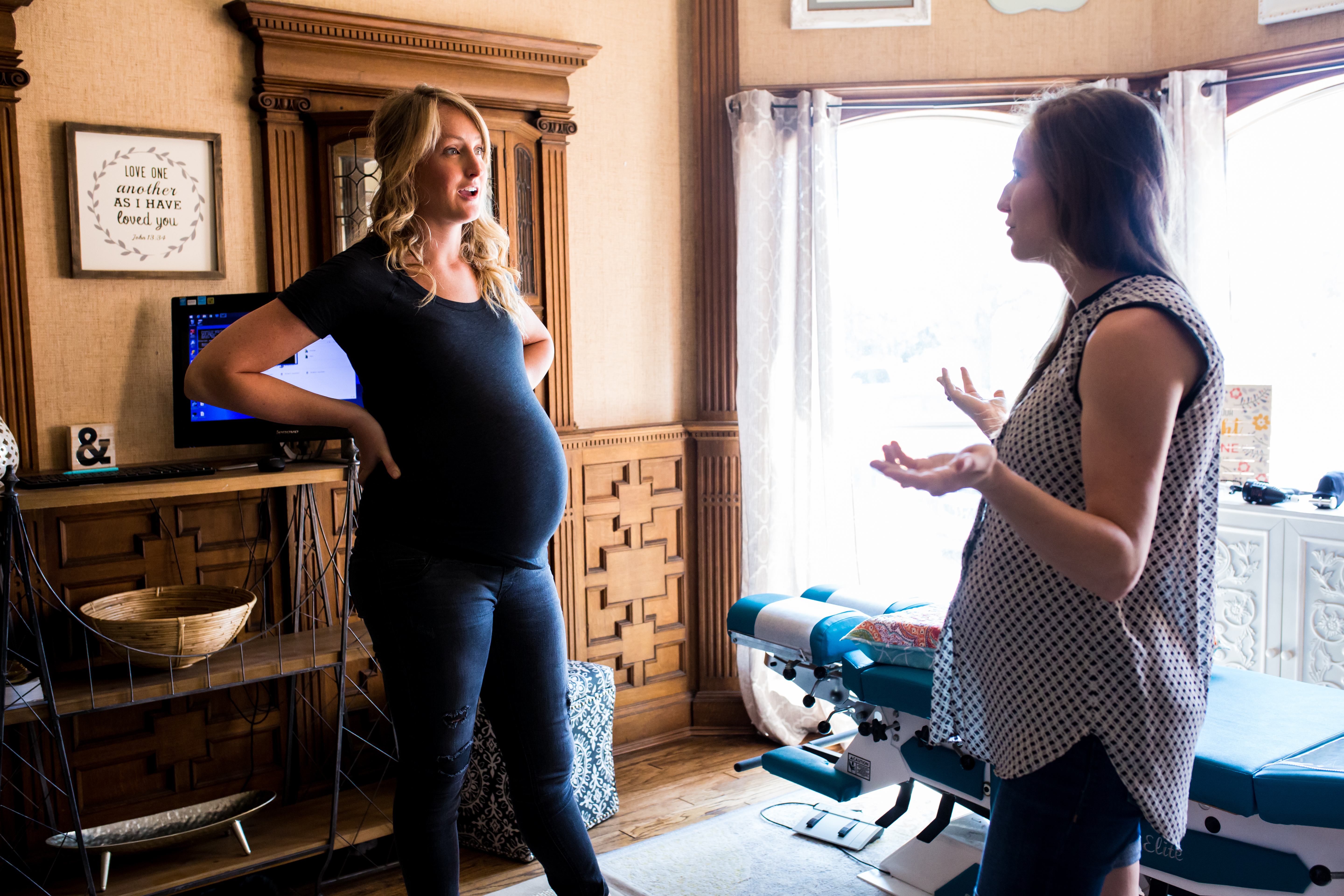 Pregnant Mom talking to pregnant chiropractor