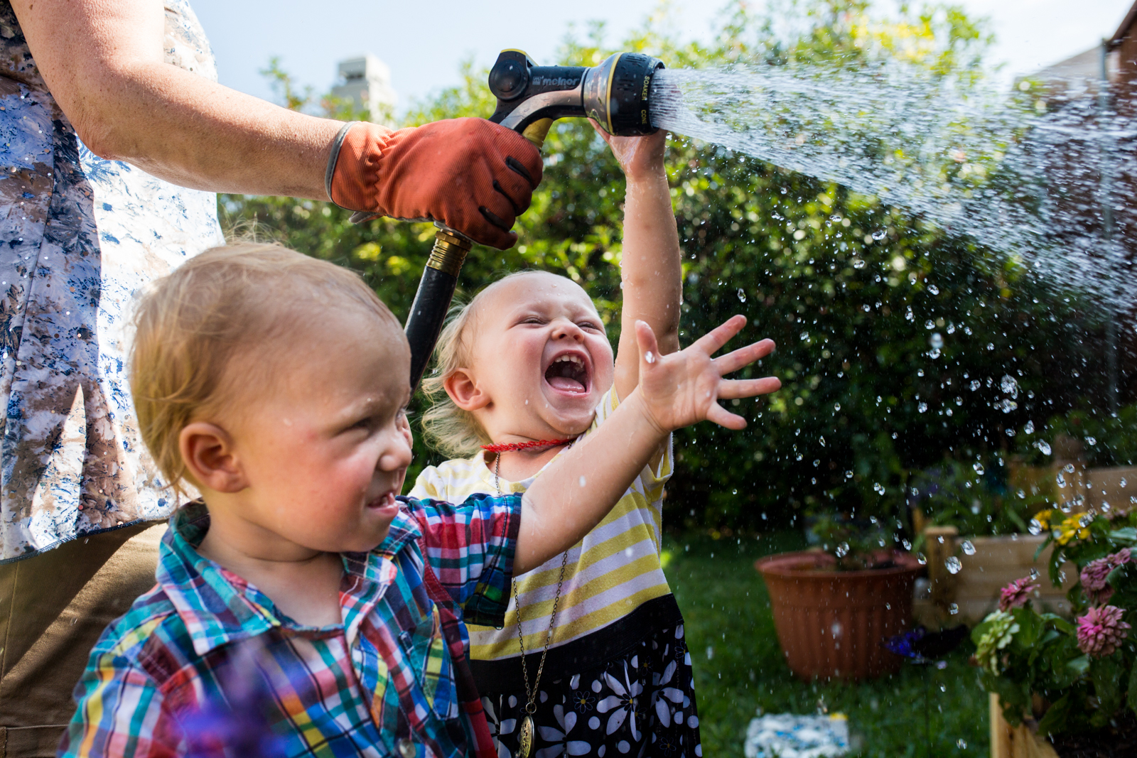Documentary Photographer and Family Photojournalist, Lawren Rose Photography, captures a funny moment where kids are laughing at water in the sky