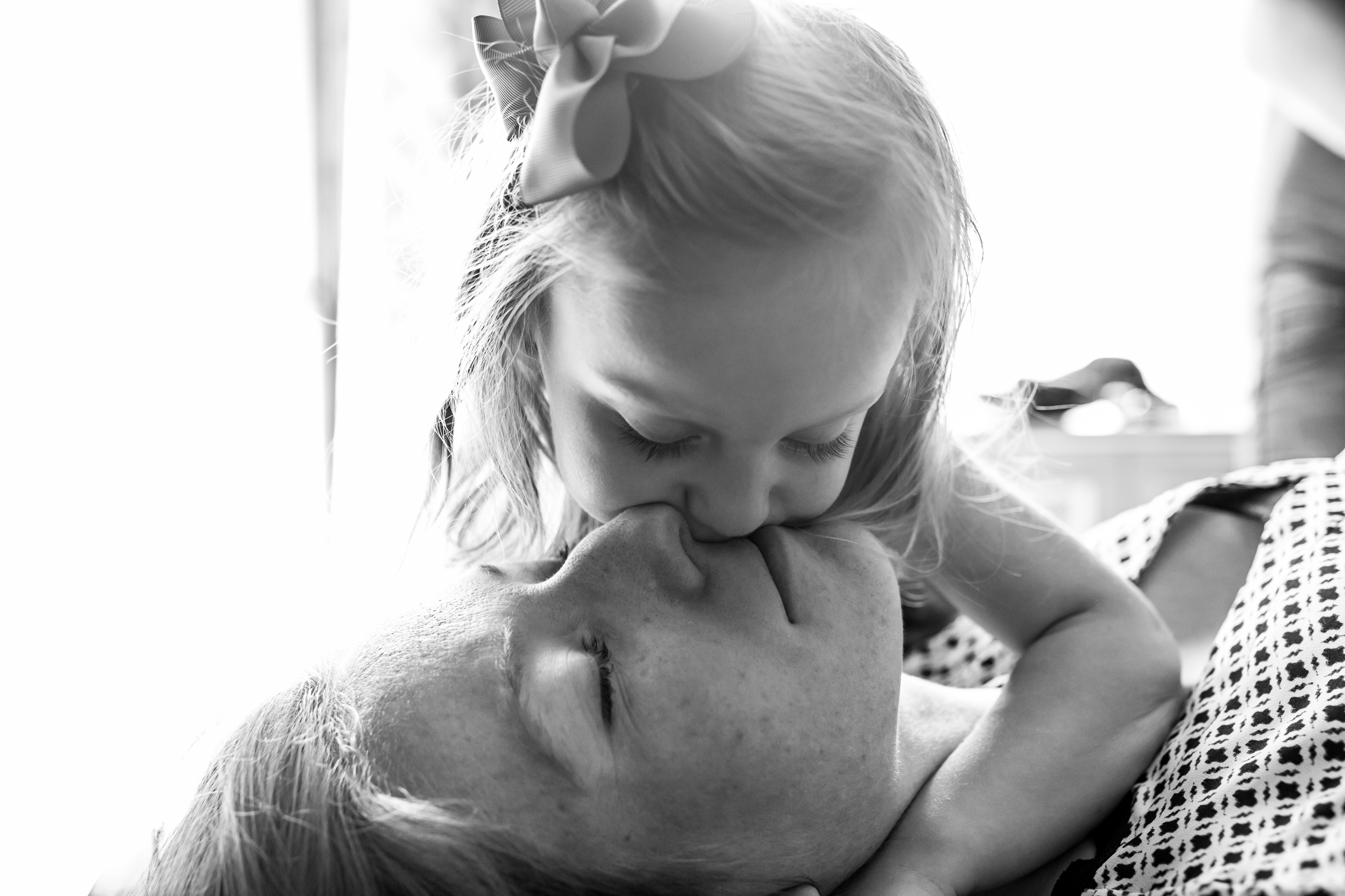 baby girl kissing her mom