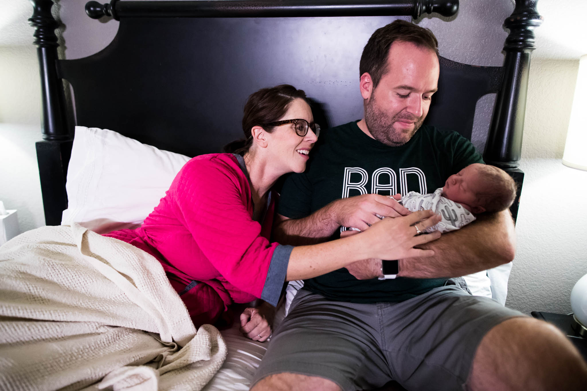 Mom and Dad get to soak in looking at their 3rd son born at home at just hours old in denton Texas, photo taken by Lawren Rose Photography
