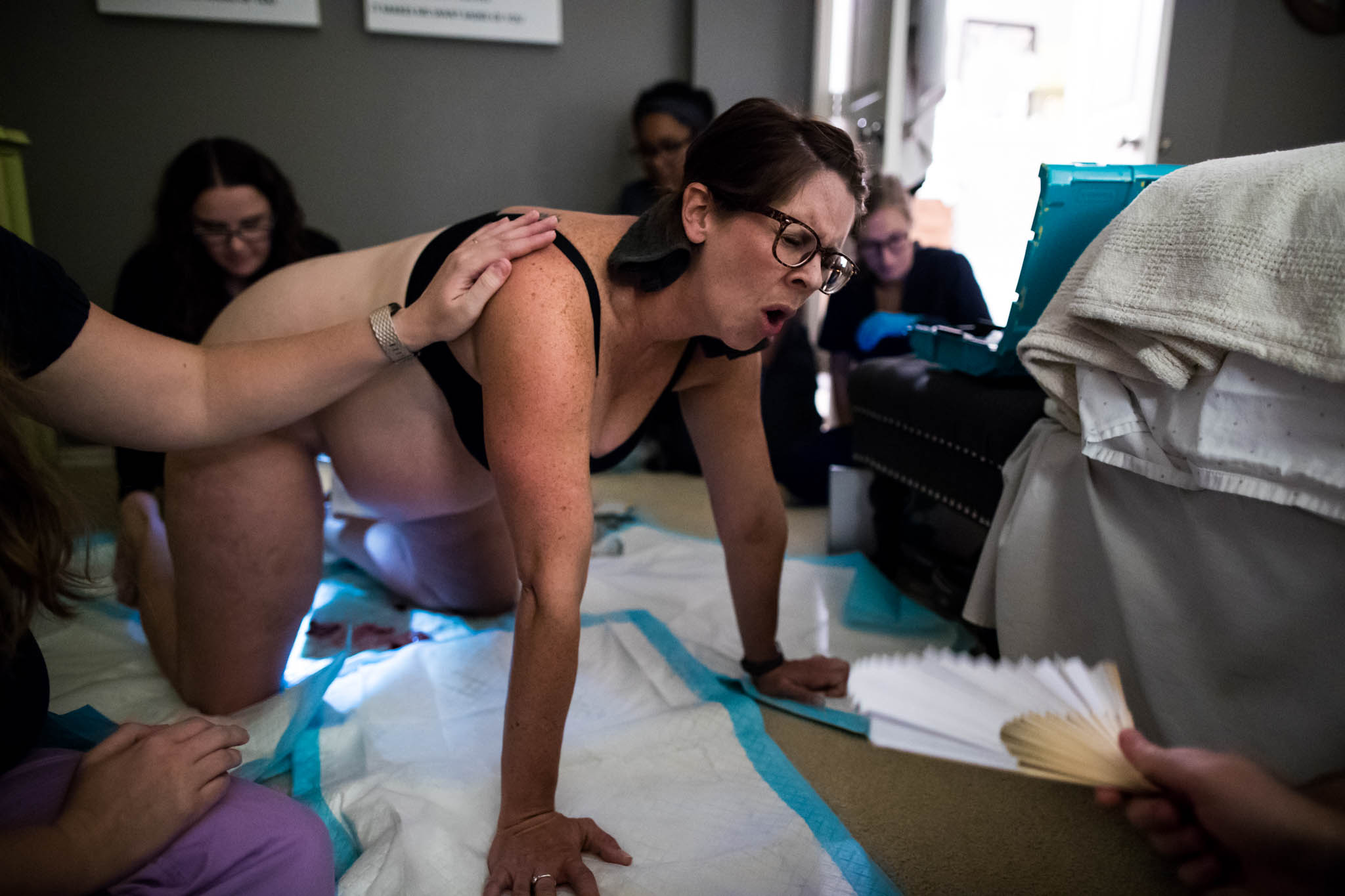 Denton Birth Photographer, Lawren Rose Photography, captures the emotions on a Mom's face as she roars in intensity from the contractions that are pushing out her baby