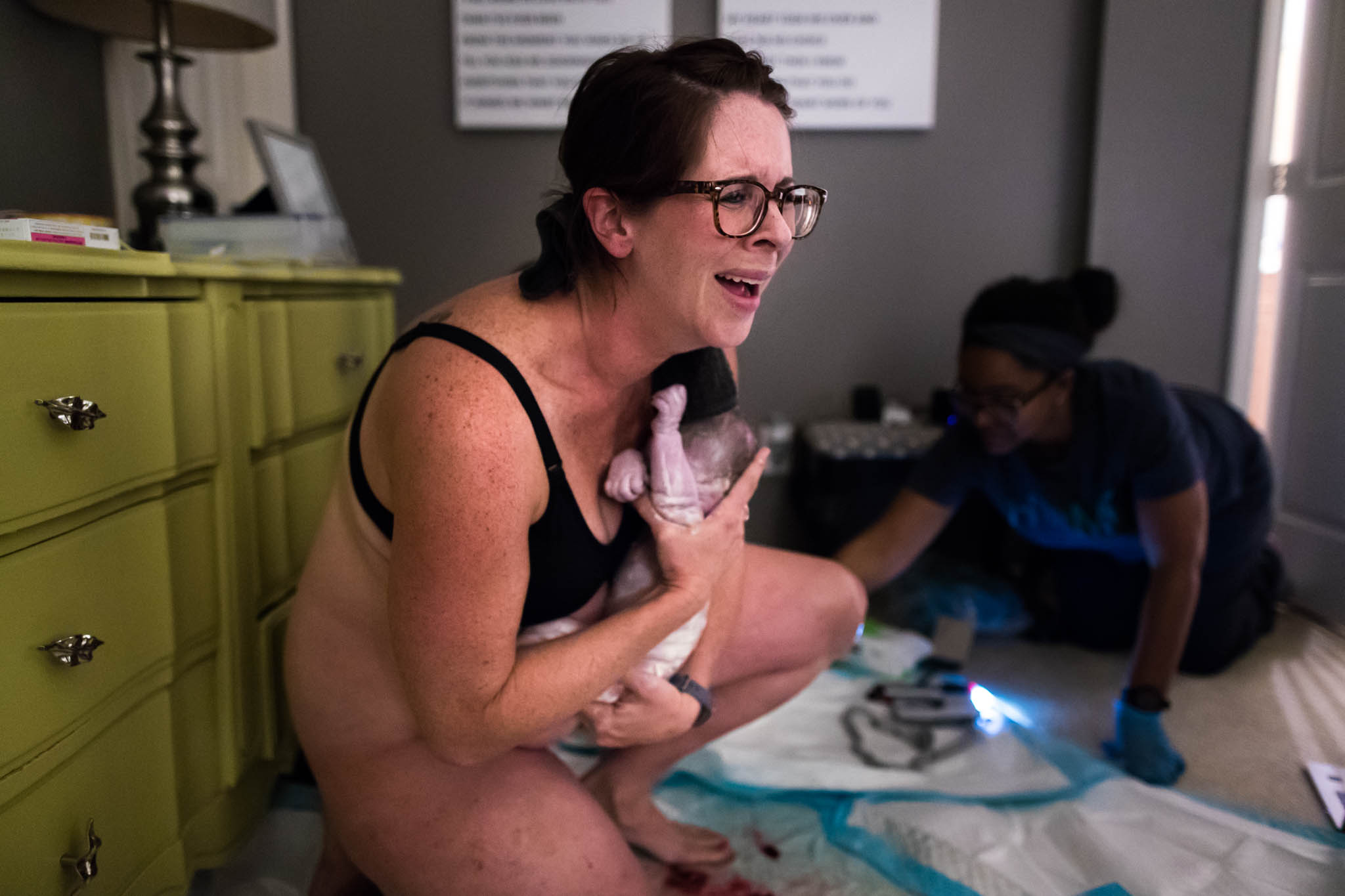Denton Birth Photographer Lawren Rose Photography captures the moment a Mom is holding her baby for the first time, with a loving and surprise look on her face