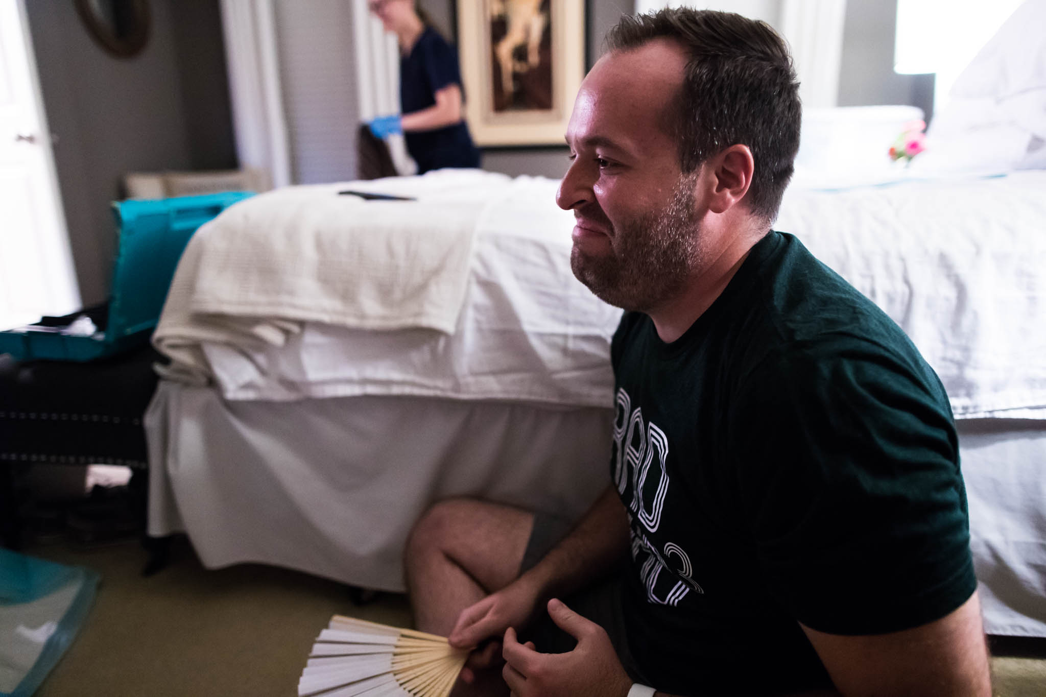 A Dallas Fort Worth Birth Photographer, Lawren Rose Photography, takes an image of a Dad seeing his baby boy for the first time during a Denton, Texas Home Birth