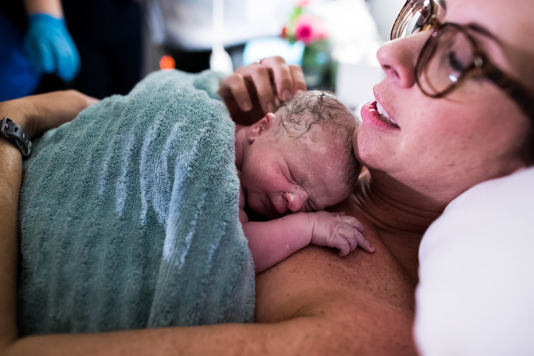 Lawren Rose Photography, a dallas birth photographer, takes an image of a brand new baby laying on his mothers chest