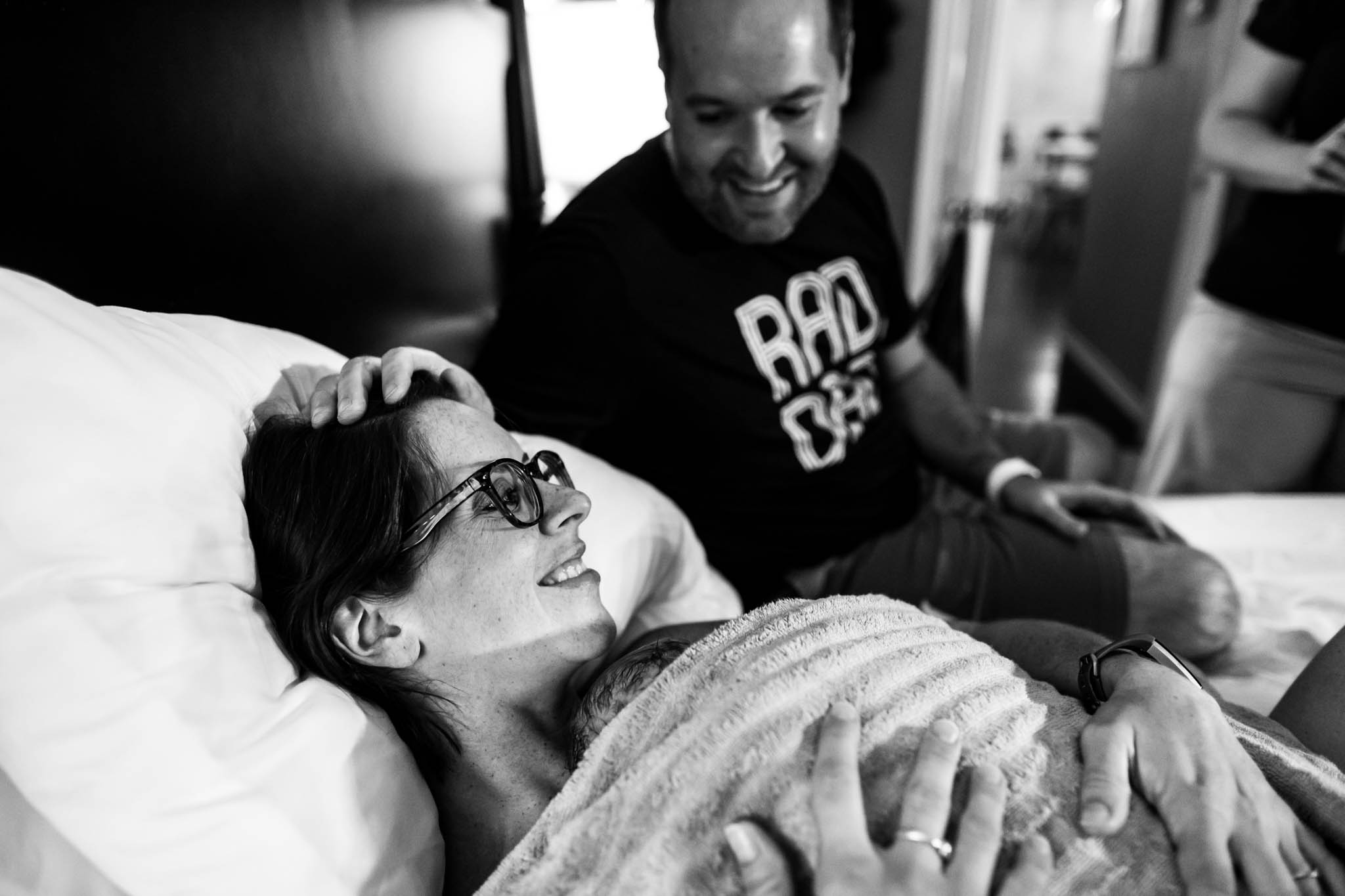 Denton Birth Photographer, Lawren Rose Photography, captures a moment between a husband and wife as he adores her for having a successful home birth